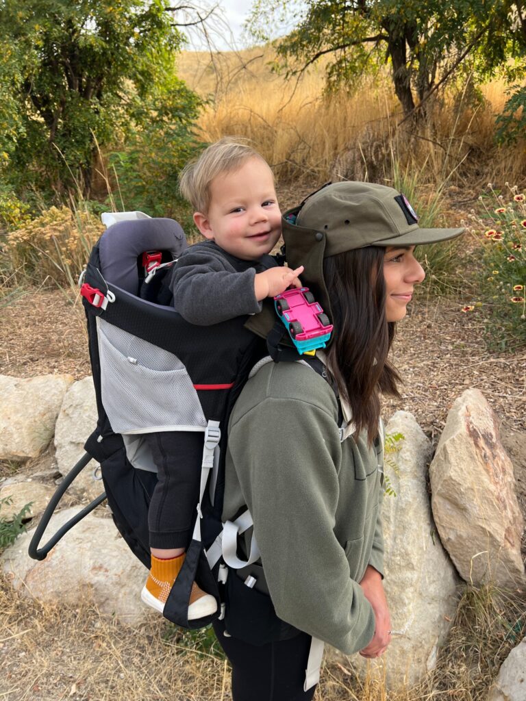 mom carrying son in hiking carrier