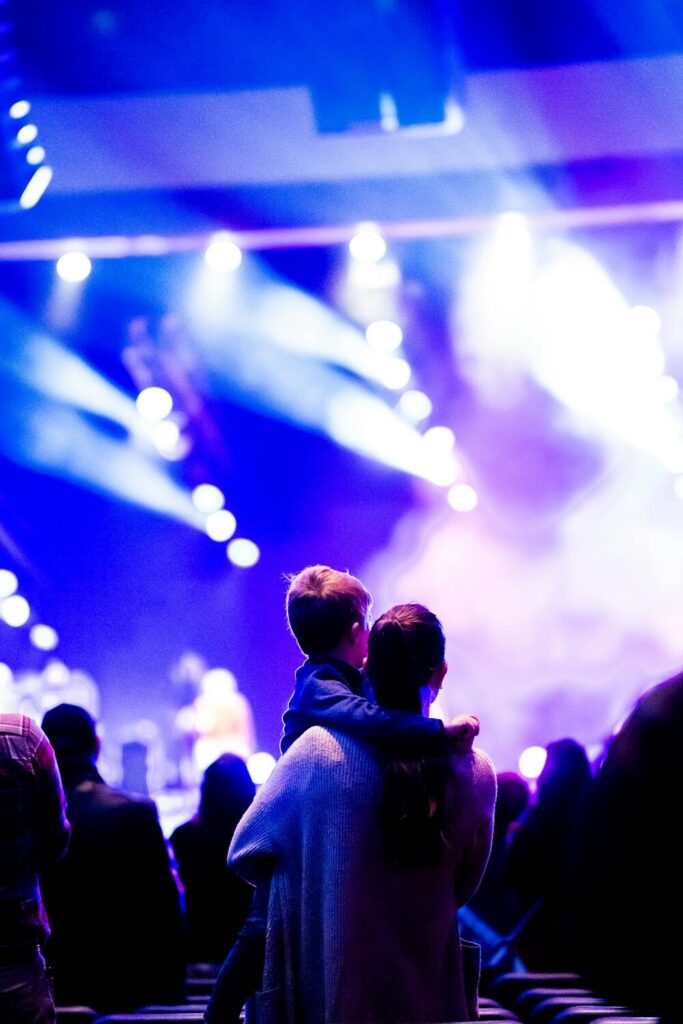 Child with parent at a night concert