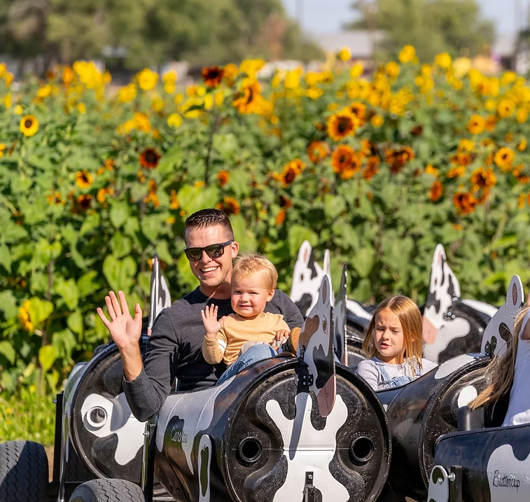 Family riding on train car