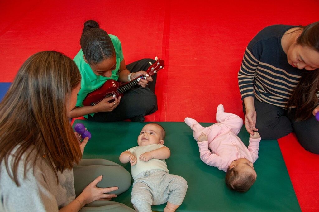 Caretakers and babies in class for movement
